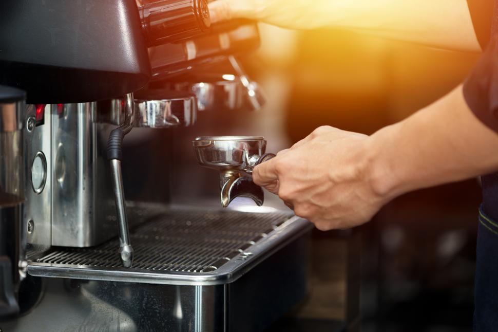 Free Image of Barista hand is making coffee with a machine. 