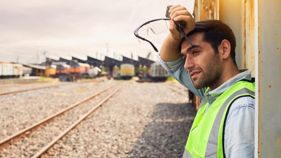 Free Image of Railway Industry Engineer standing beside the Freight Train 