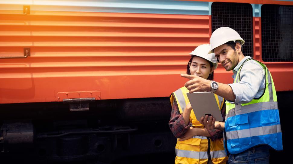 Free Image of Train engineers or railway experts confer with each other 