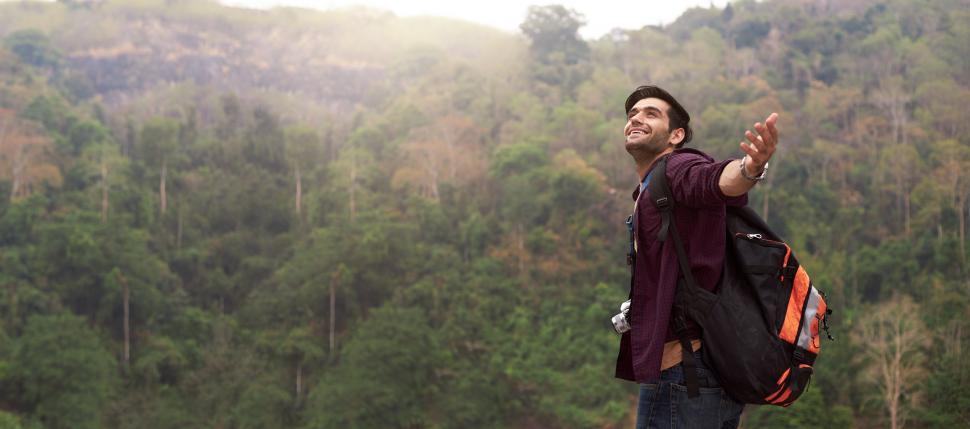 Free Image of Male backpacker tourist enjoys traveling in nature 