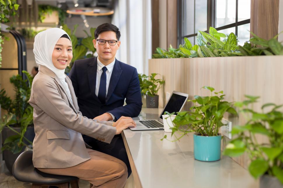 Free Image of Young multi-ethnic business people sitting working together 
