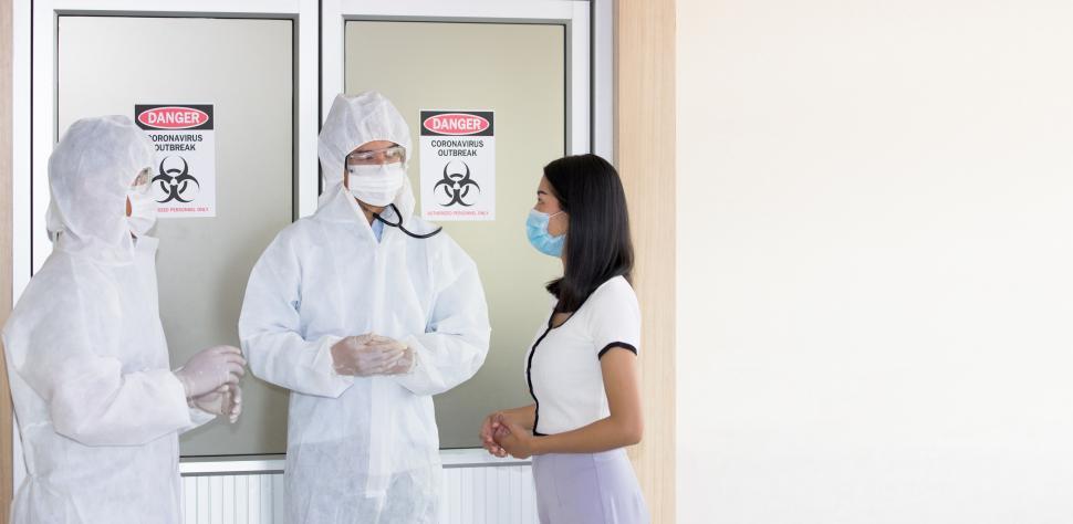 Download Free Stock Photo of Medical workers in full PPE outside emergency room 