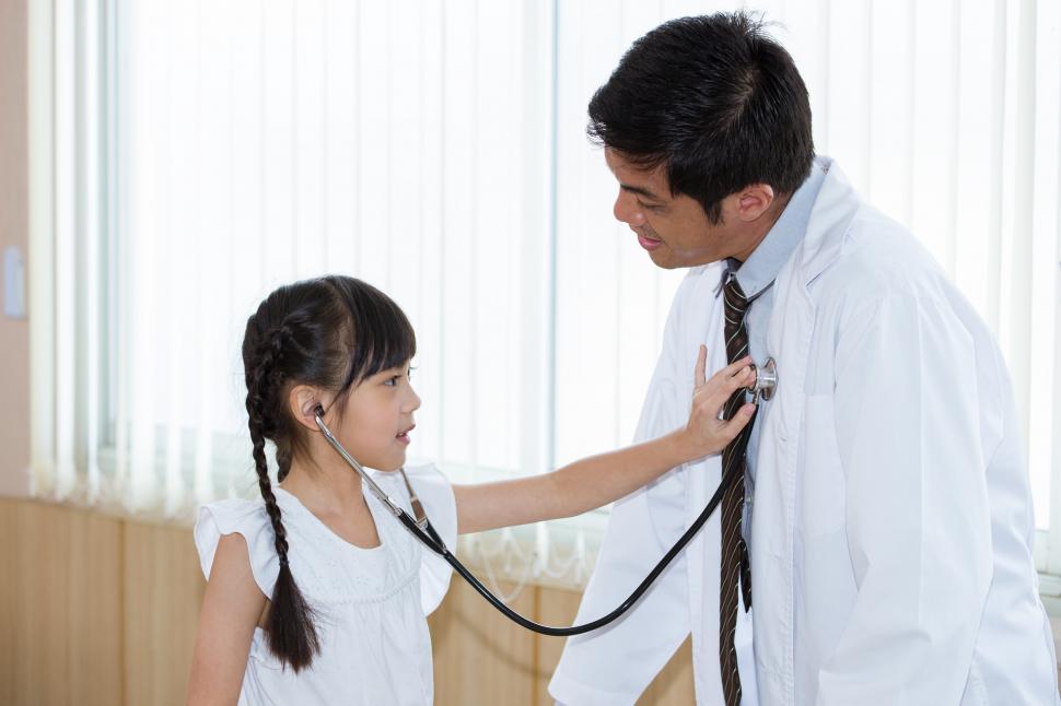 Download Free Stock Photo of Child listening to her doctors heart 