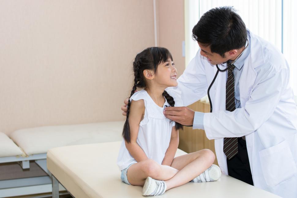 Download Free Stock Photo of Doctor examining young patient 