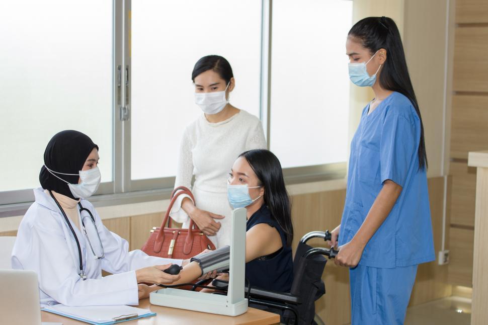 Download Free Stock Photo of People wearing surgical masks at the hospital 