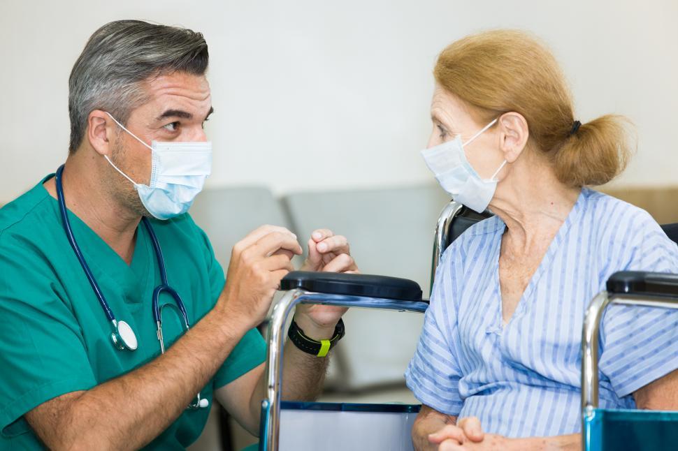 Free Image of Nurse introducing health care to elderly patient 