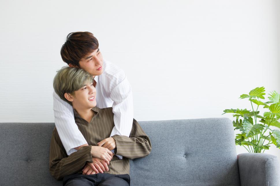 Free Image of Couple sitting on the sofa in a happy time 