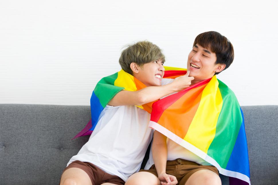 Free Image of Gay couple with a rainbow pride flag 