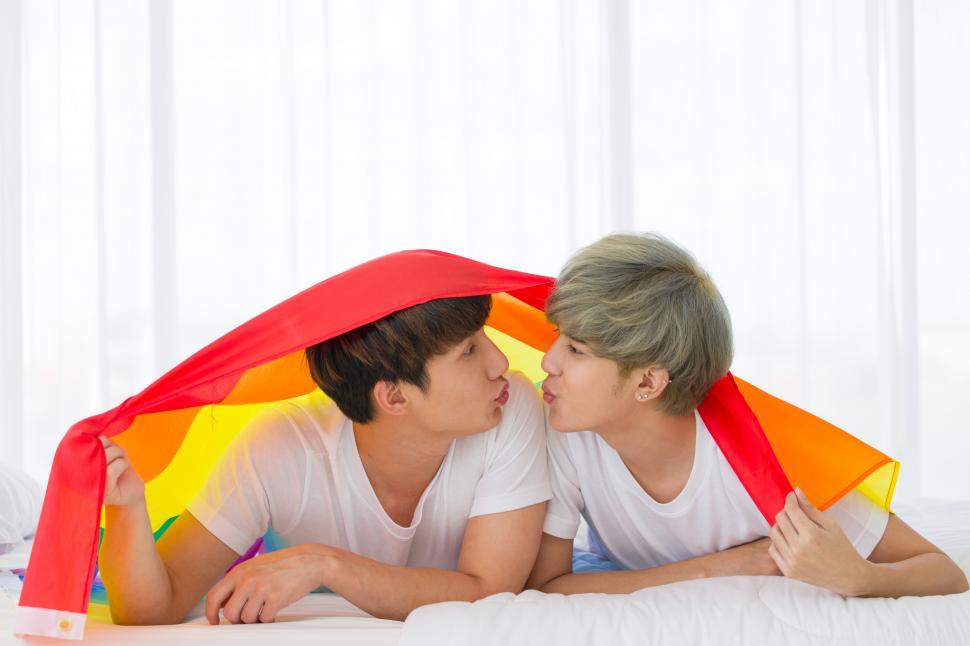 Free Image of LGBT couple under rainbow flag. 