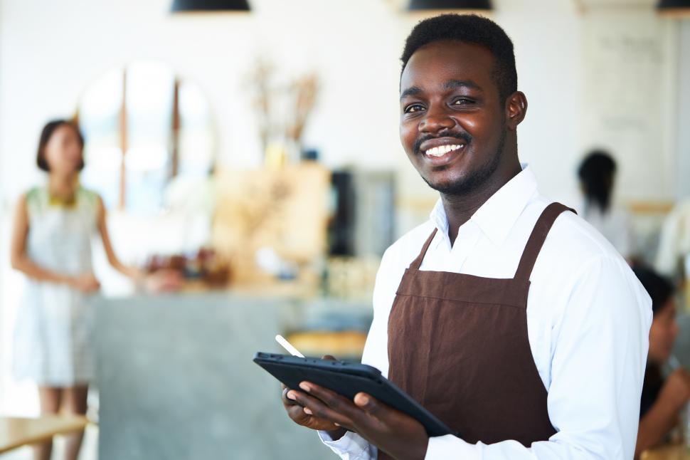 Download Free Stock Photo of Waiter standing and smiling 