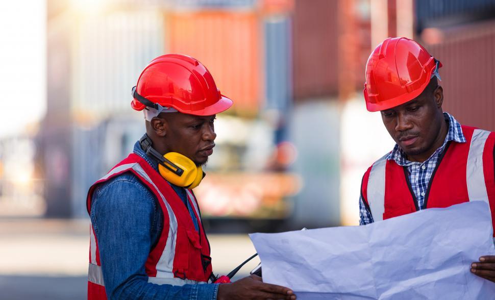 Download Free Stock Photo of Engineers managing work in a container yard 