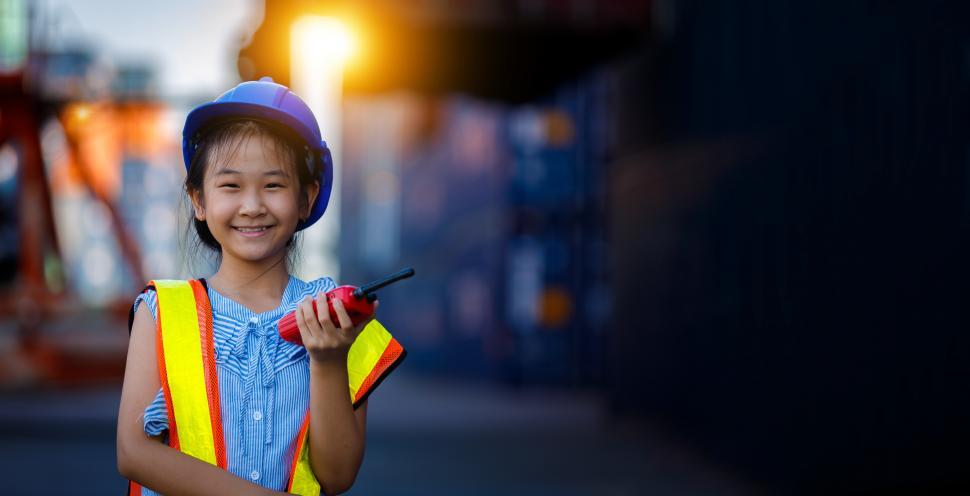 Download Free Stock Photo of A girl dressed as an engineer holding walkie-talkie. 