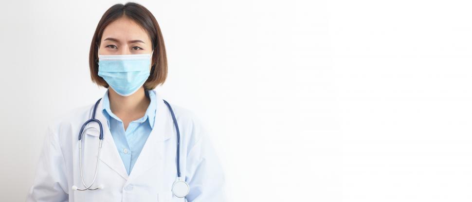 Download Free Stock Photo of A woman doctor wearing a mask with blank copyspace 