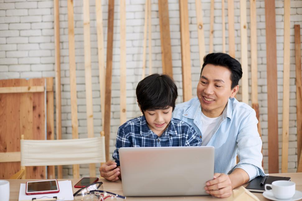 Free Image of Father and son are helping to design a wooden house 