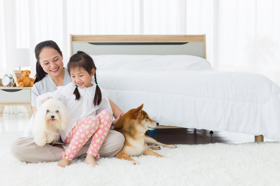 Free Image of Mom and daughter with dog in bedroom 