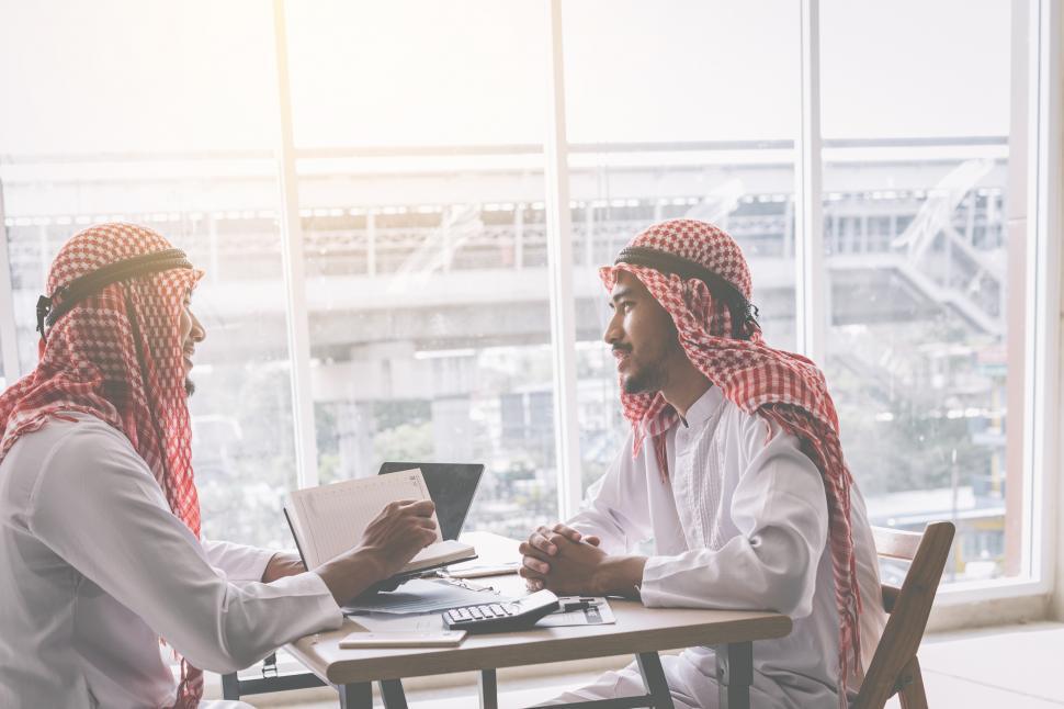 Free Image of Two Arab business people working together in an office 