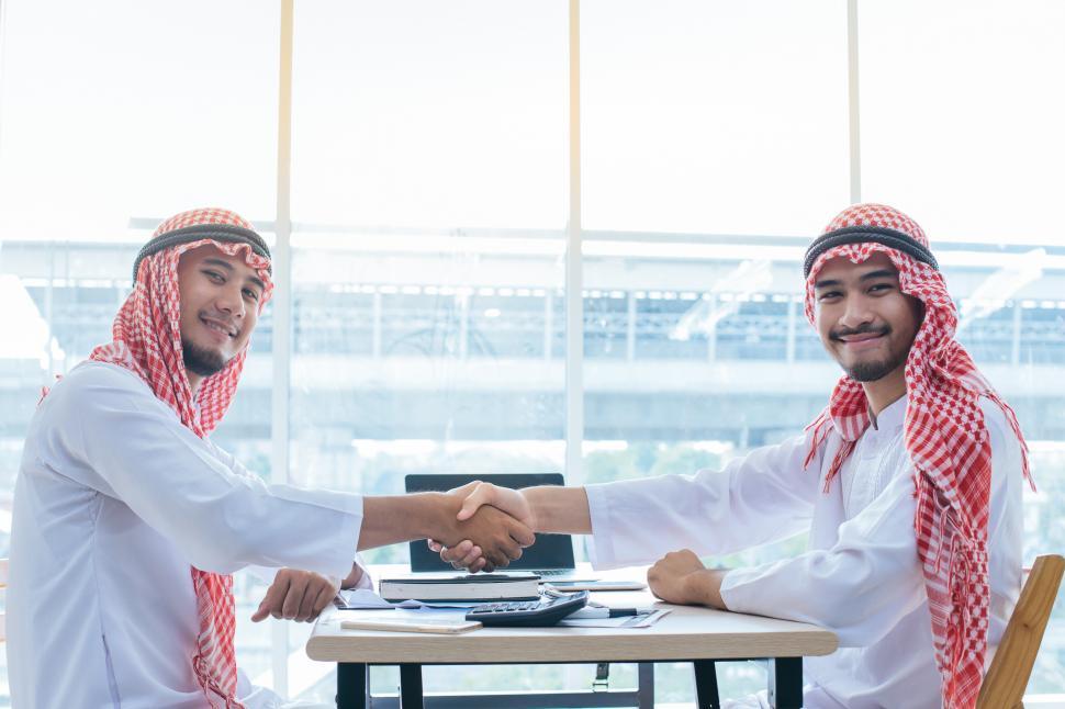 Free Image of Young Arab businessman shake hands in agreement 