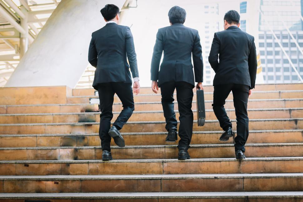 Free Image of Portrait of three businessmen climbing steps 