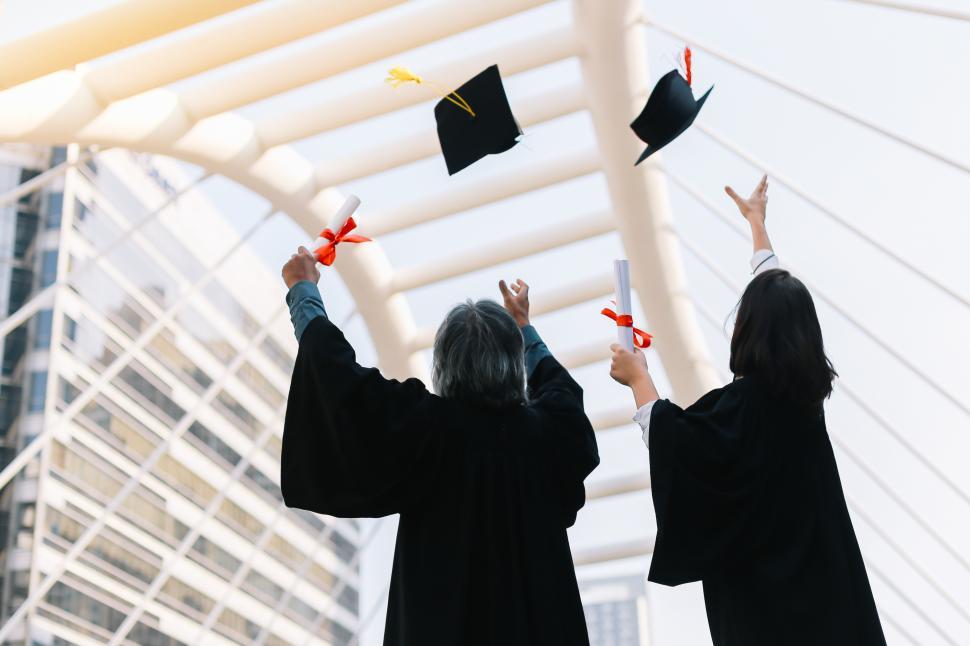 Free Image of Graduates throw mortarboards in celebration 