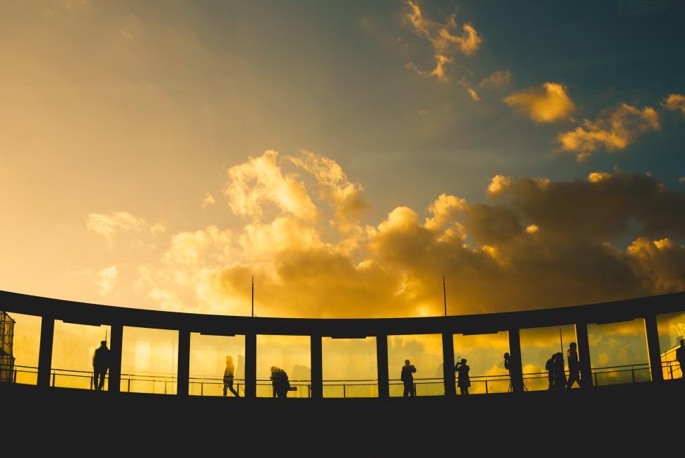 Free Image of Silhouette of a group of people standing watching the sunset 