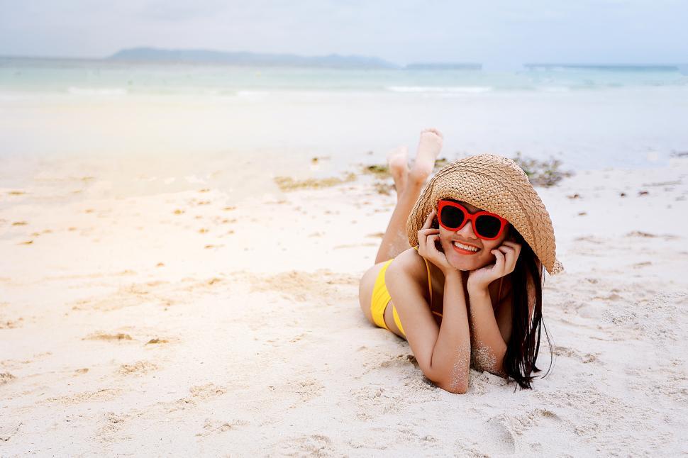 Free Image of Happy woman in sunglasses and bikini on the beach 