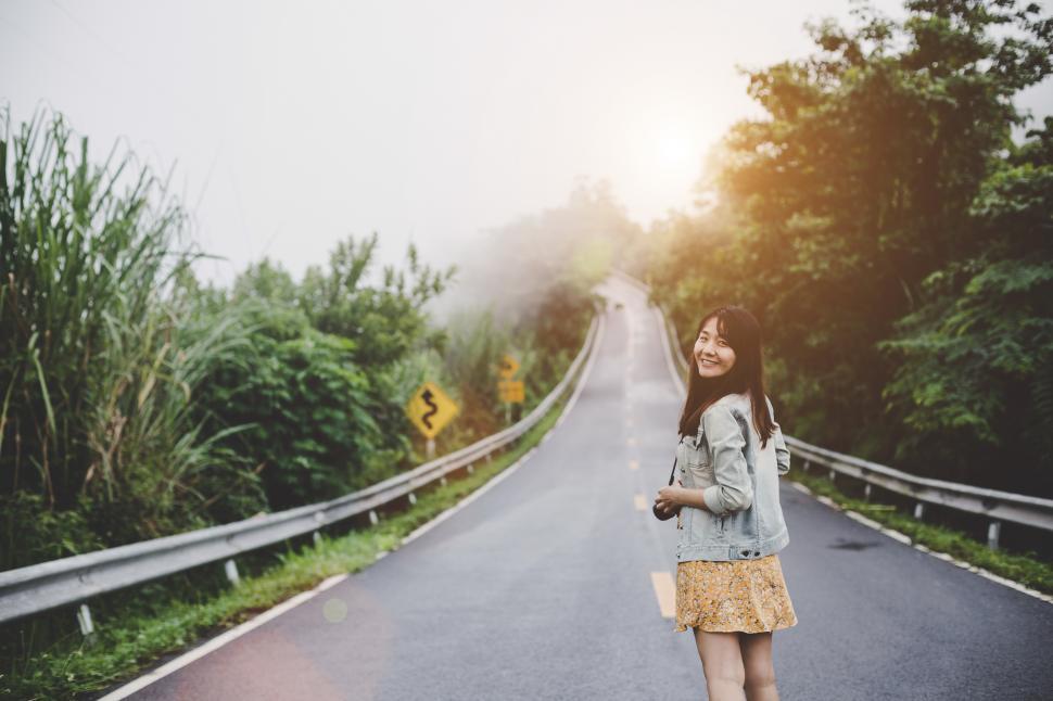 Free Image of Travel woman with backpack enjoys the refreshing air 