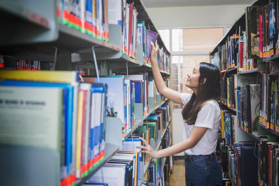 Download Free Stock Photo of Woman in the library stacks 