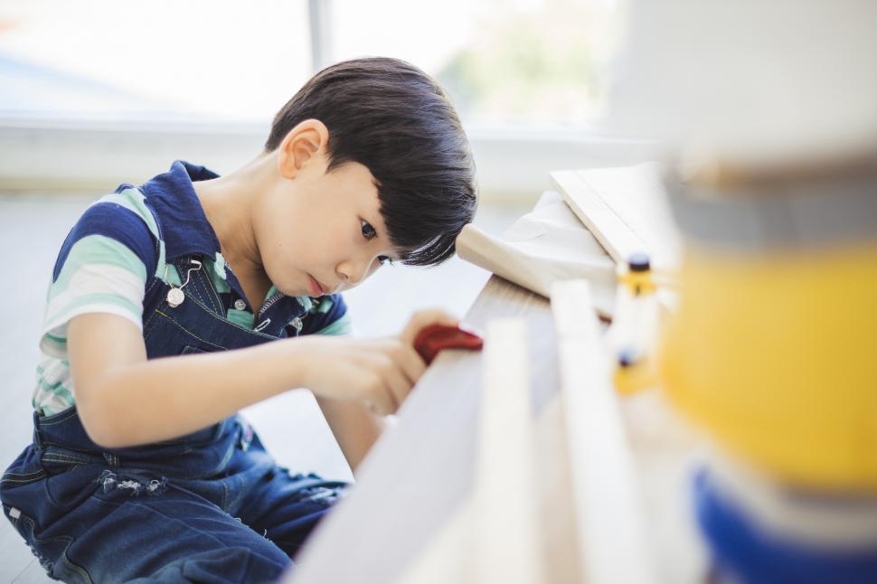 Free Image of Young boy using tools 