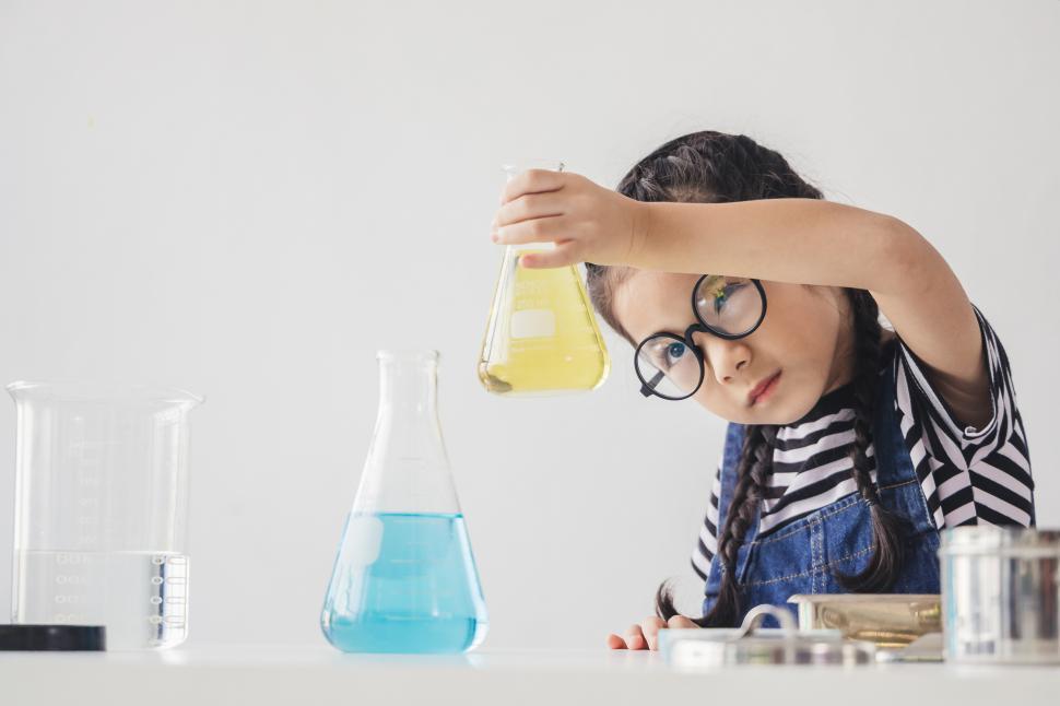 Free Image of Little scientists children is looking at erlenmeyer flask. STEM.  