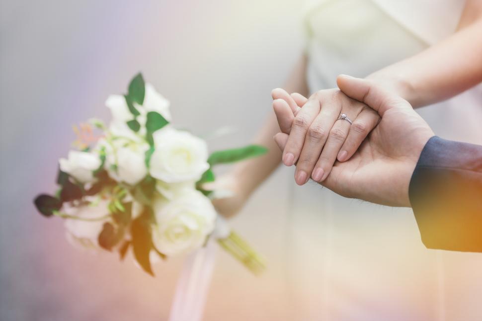 Free Image of Groom holding the brides hand 