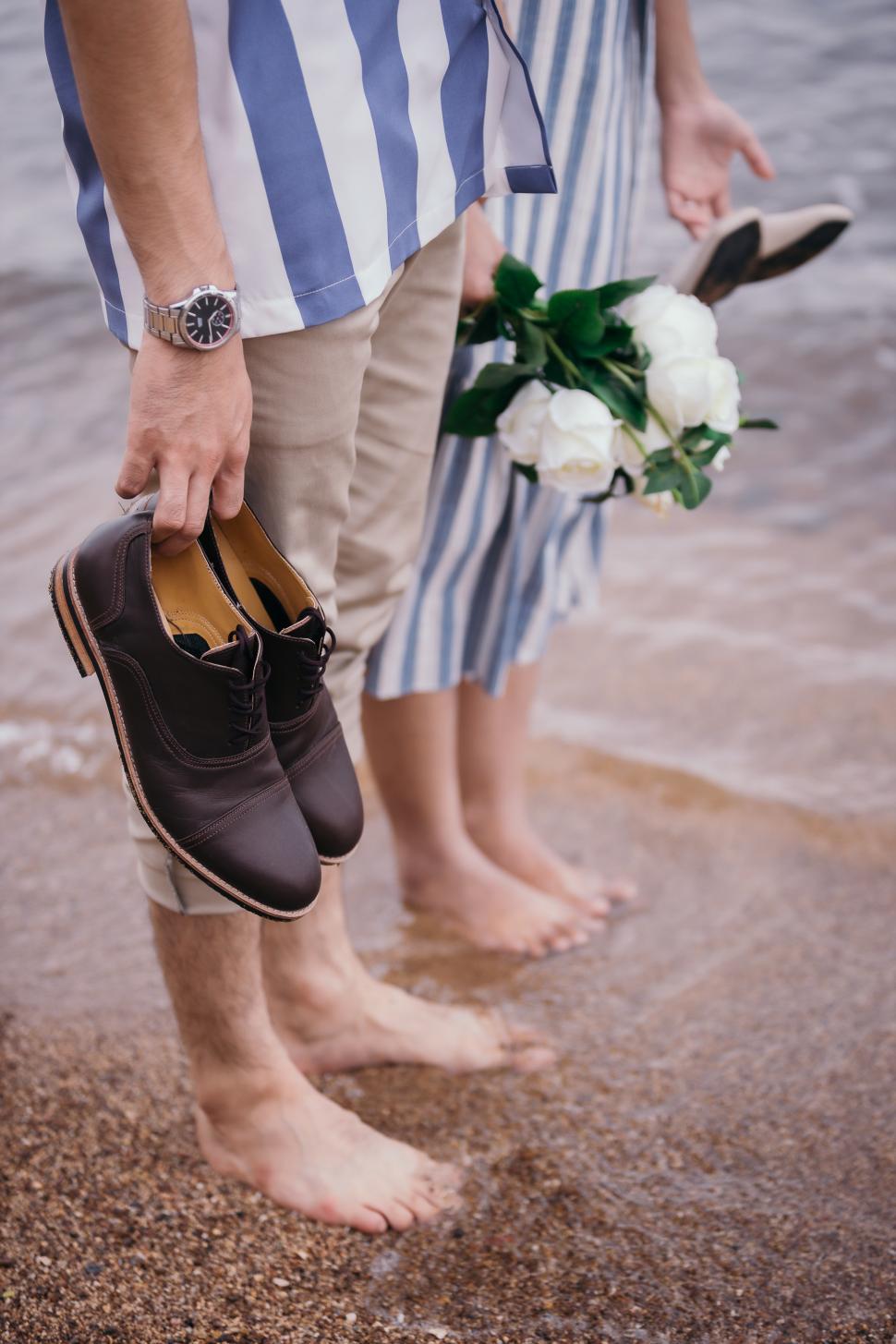 Free Image of Close-up photos of a bouquet of flowers and shoes, the groom and bride 