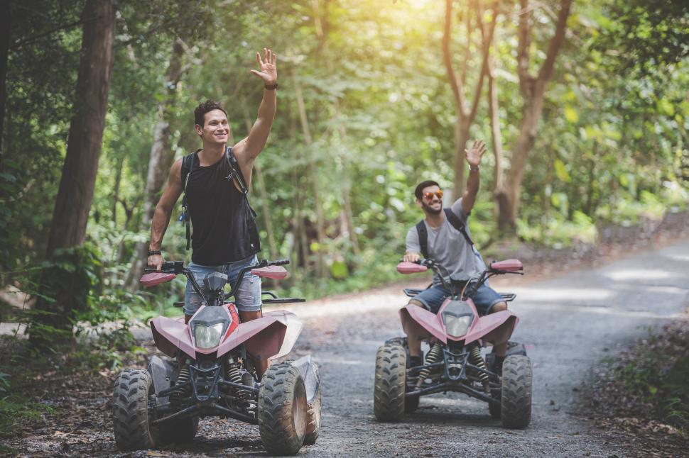 Download Free Stock Photo of Off road motorcycle ATV riders waving 