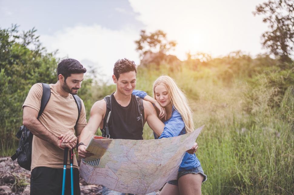 Download Free Stock Photo of Group of adventurers looking at a map 