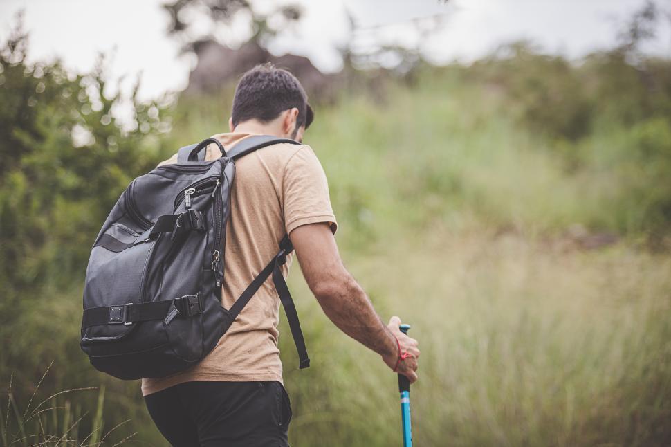 Download Free Stock Photo of Hiker with a backpack and a hiking pole 