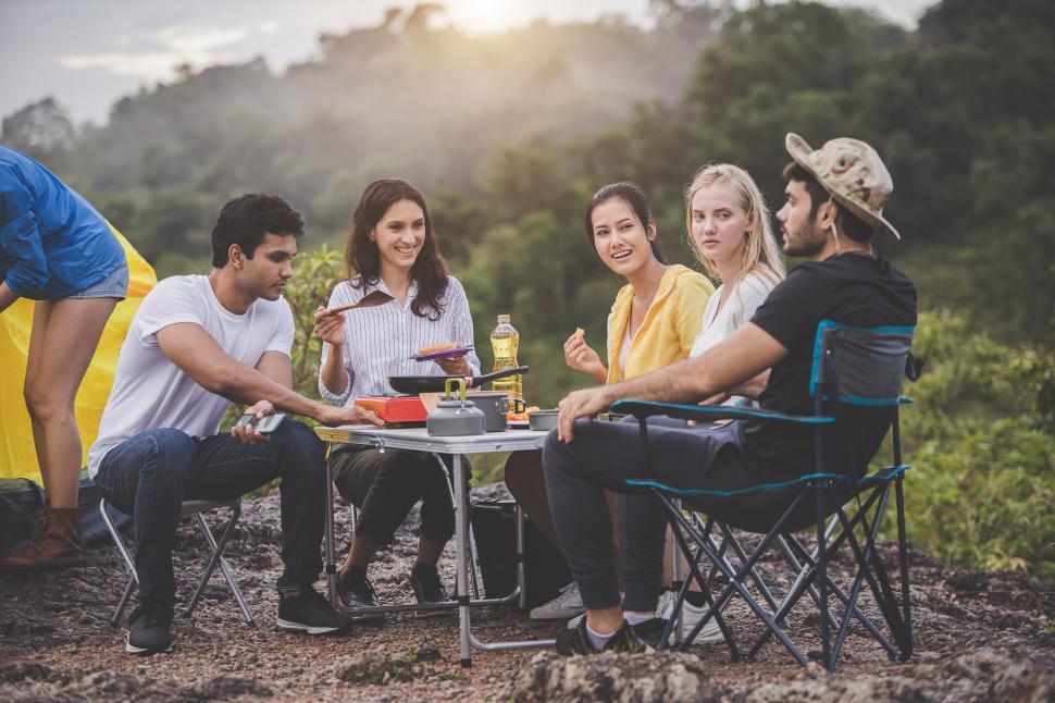Free Image of Group camping concept - Happy friends grilling and cooking  