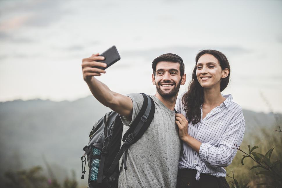 Download Free Stock Photo of Young couple smile happily for a selfie 