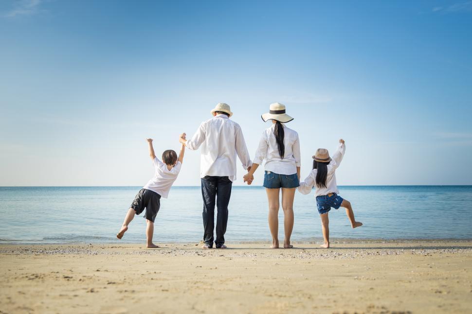 Download Free Stock Photo of Family holding hands at the beach 