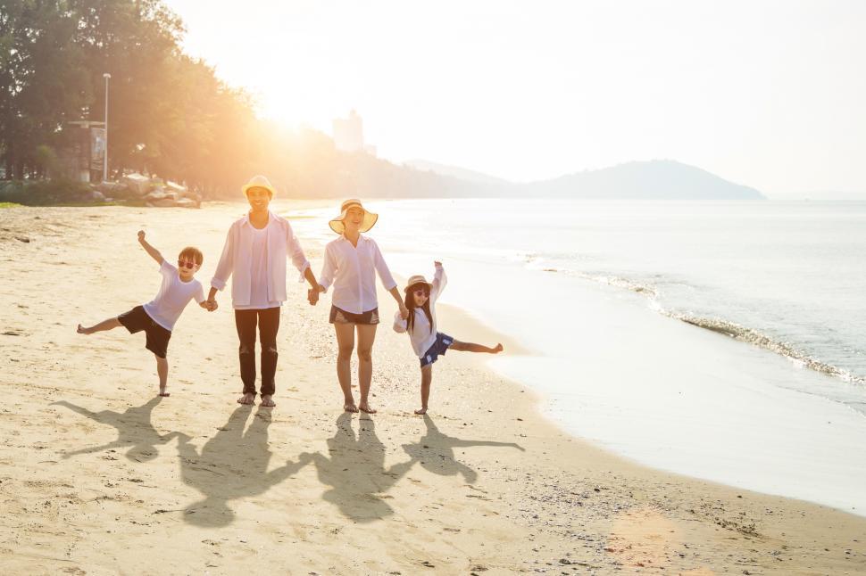 Free Image of Family walking on the beach - summer vacation. 