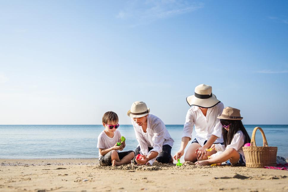 Free Image of Young family with children laughing at the beach 