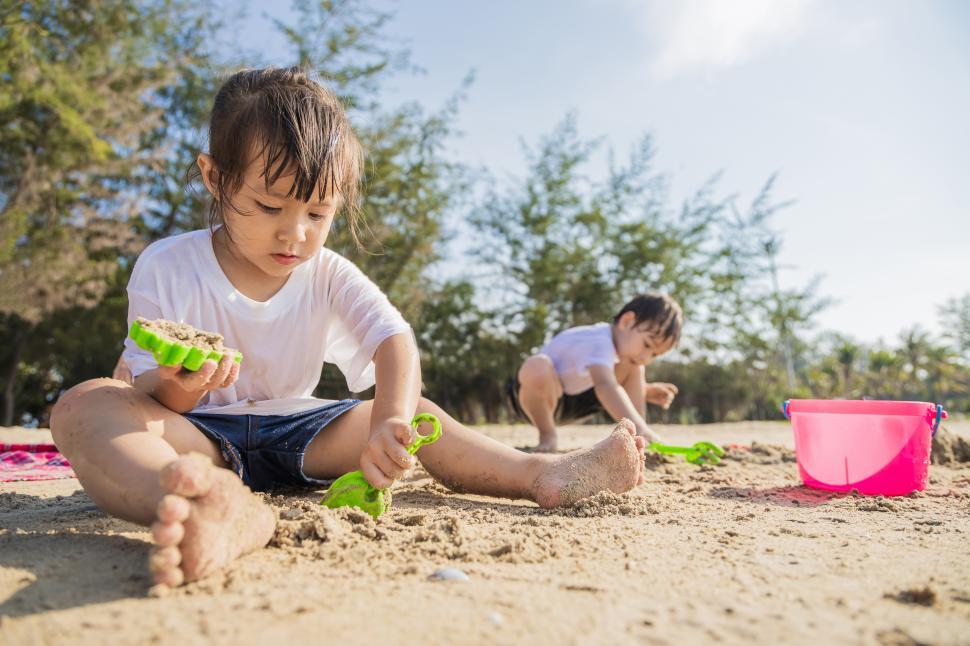 Free Image of Children playing in beach sand 