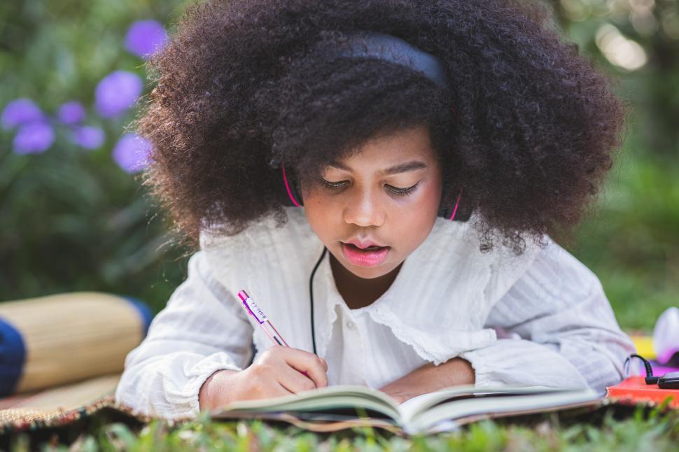 Free Image of Little girl working in her notebook  