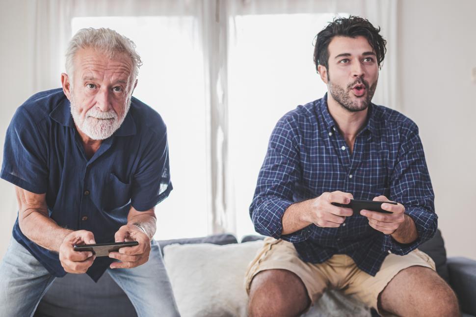Free Image of Father and son compete in online games on smartphones 