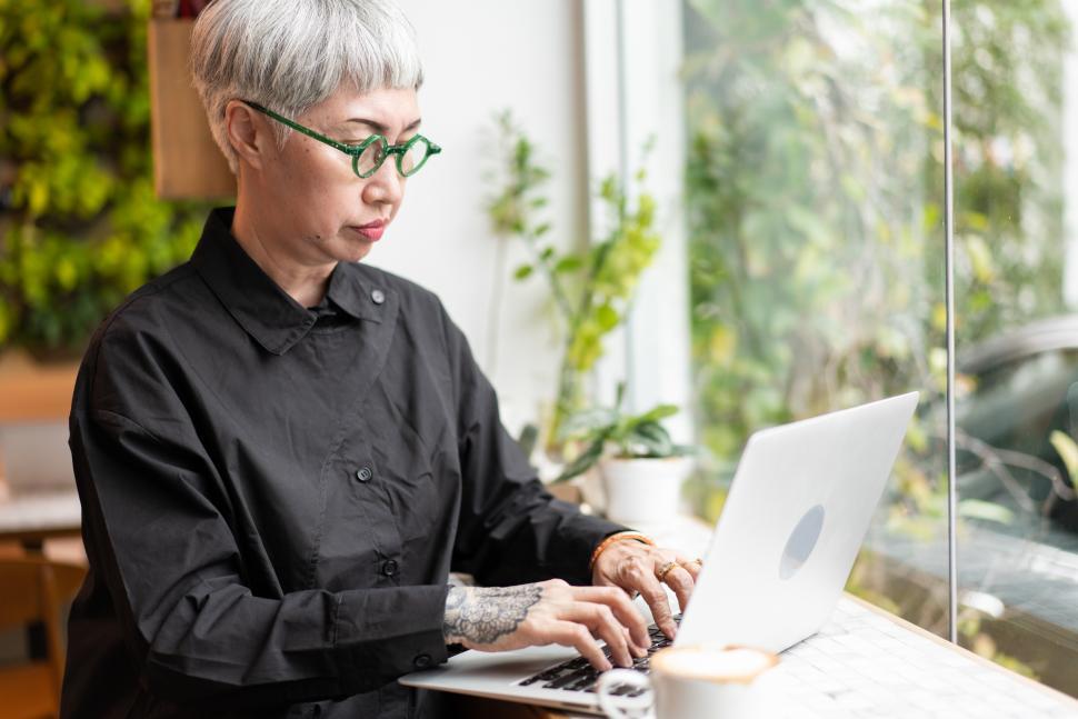 Free Image of Senior woman watching and working on laptop 