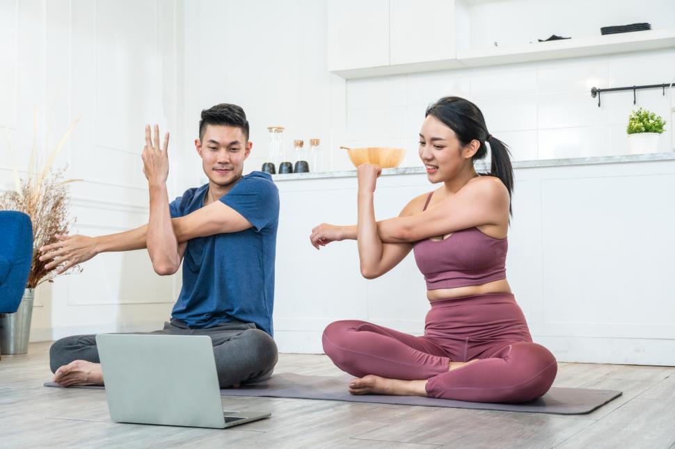 Free Image of Young sporty couple watching video practice yoga lesson  