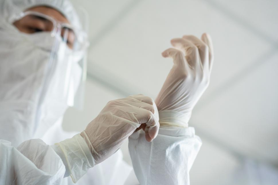 Free Image of Medical staff in PPE suit wearing protective glove 