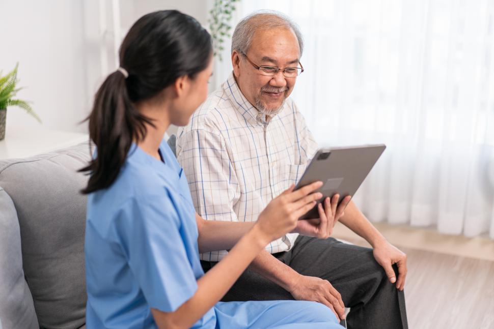 Free Image of Nurse showing health checkup report to grandfather 