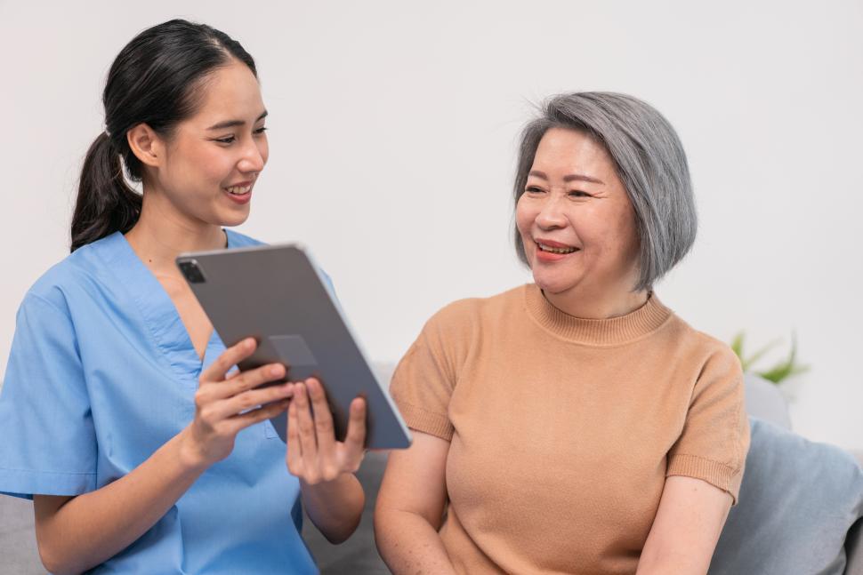 Free Image of Nurse showing health checkup report to grandmother 