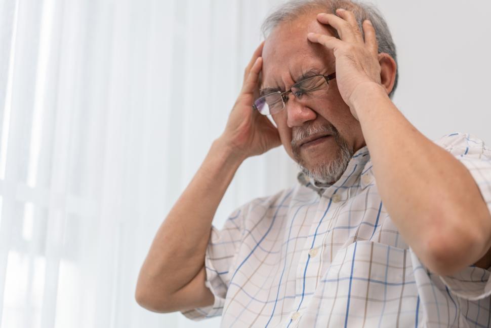 Download Free Stock Photo of Senior man having headache. Stressed and depressed. 