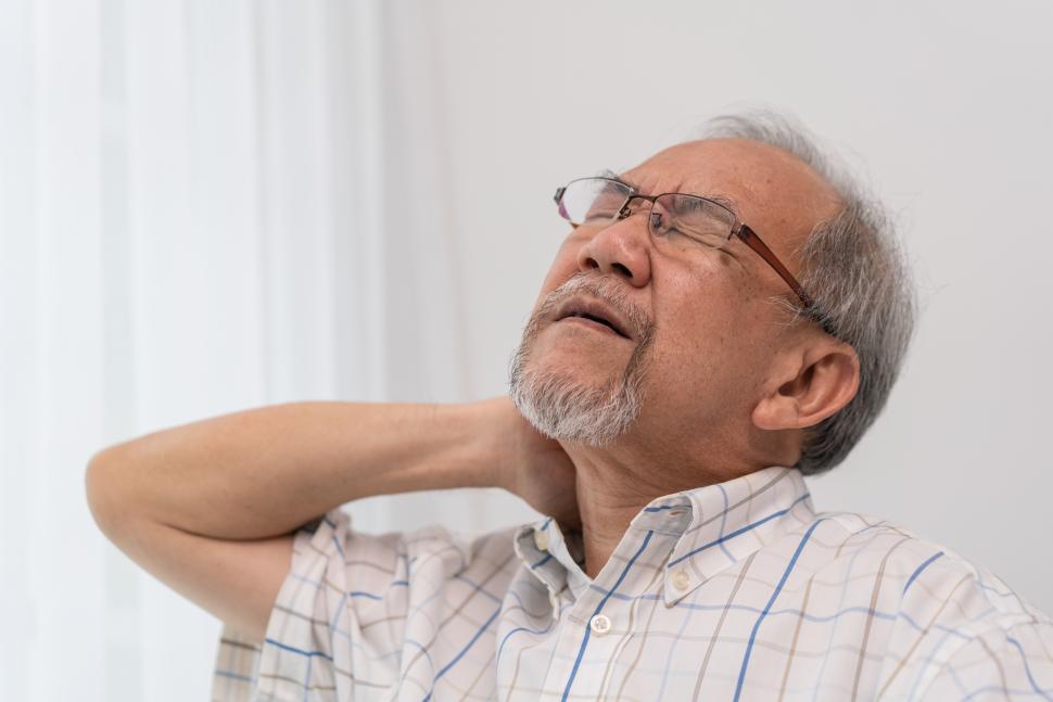 Download Free Stock Photo of Senior adult has neck pain 