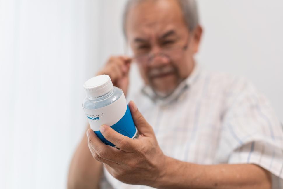 Free Image of Senior man with farsighted reading prescription on medicin 